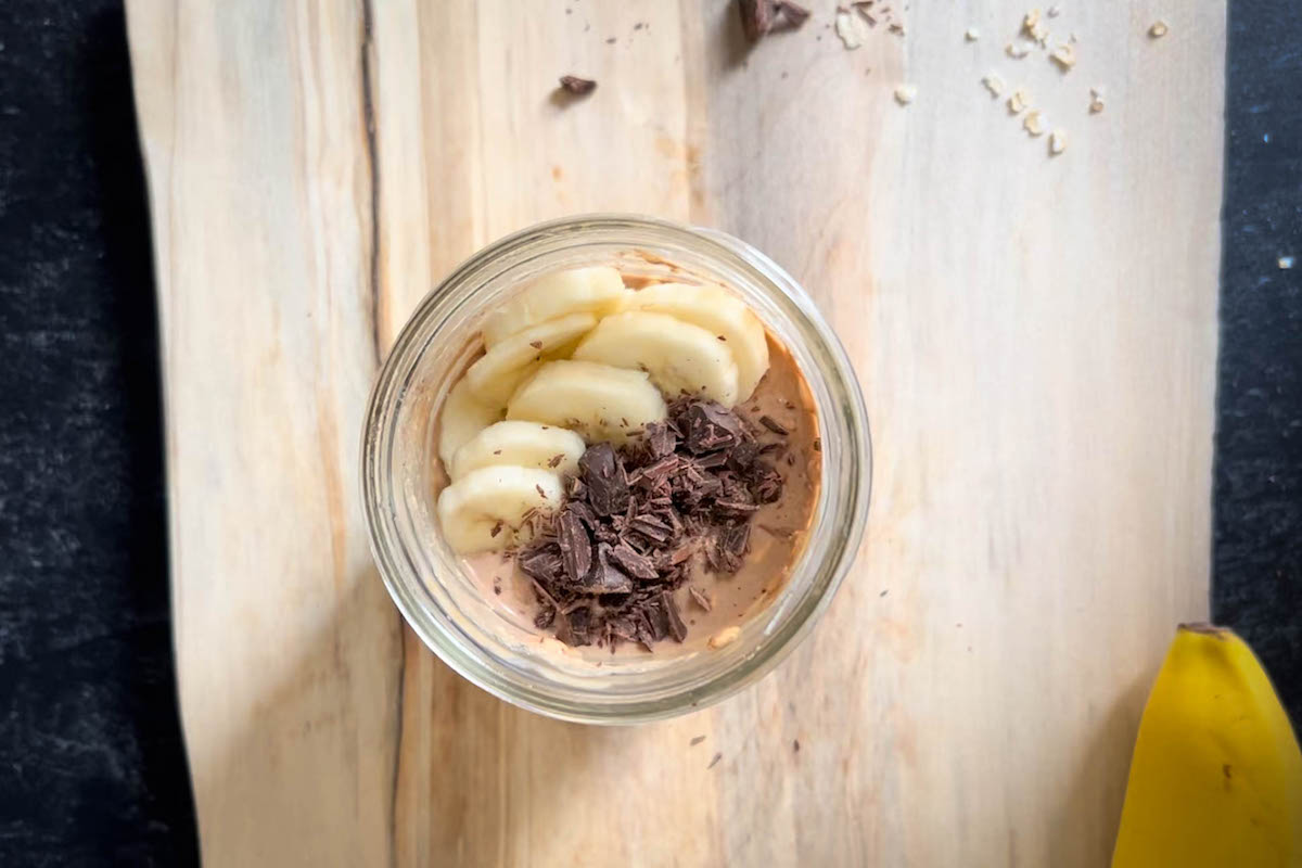 A glass full of banana chocolate overnight oats