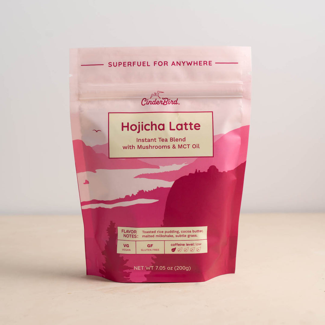 Pink package of Hojicha Latte instant tea blend with mushroom and MCT oil on a light background
