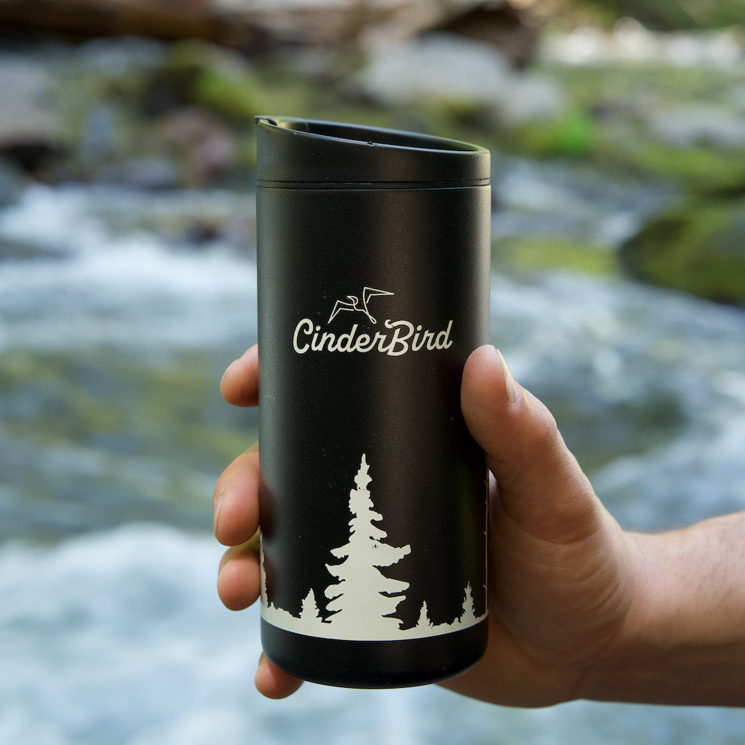 CinderBird travel thermos by a river