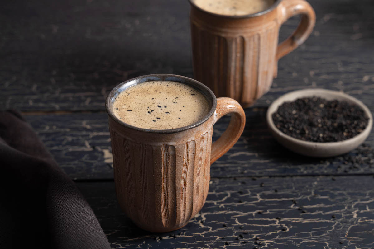 Two mugs of black sesame hojicha latte