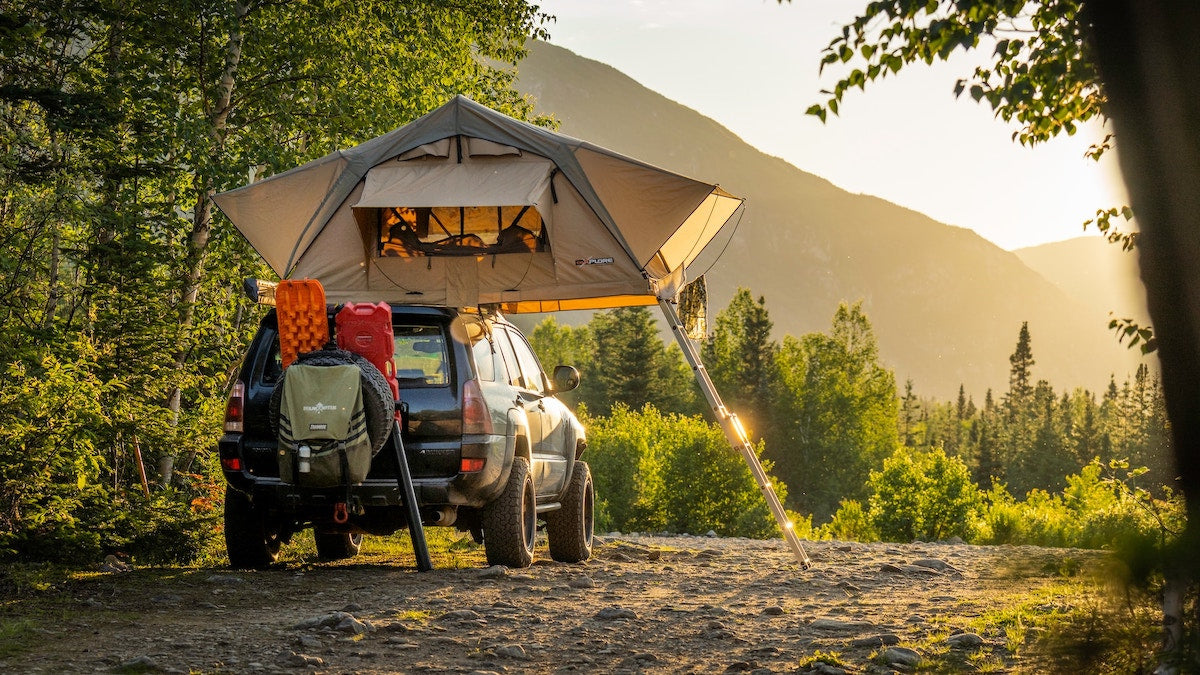 A rooftop tent set up at camp